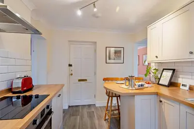 a kitchen with a wooden counter top and a table at 1 Bed in Wymondham oc-w30597 in Wymondham