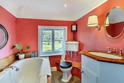 a bathroom with a tub and a toilet and a sink at 6 Bed in Wymondham oc-t30598 in Wymondham