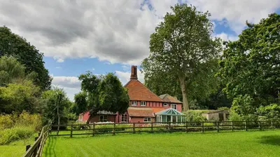 an old red house with a fence in a field at 6 Bed in Wymondham oc-t30598 in Wymondham