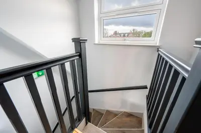 a stairwell with a window and a stairway at Newmarket House 5 Bedroom 5 En-suite Free Parking in Newmarket