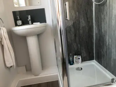 a bathroom with a shower and a sink at Abbeyfield Guesthouse in Cambridge