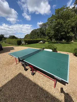 a green ping pong table on a gravel ground at Meesden Hall in Meesden