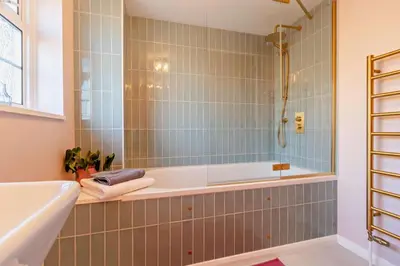 a bathroom with a tub and a shower and a sink at 2 Bed in Nacton oc-c30257 in Nacton