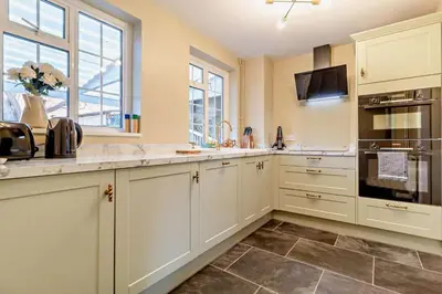 a kitchen with white cabinets and a counter top at 2 Bed in Nacton oc-c30257 in Nacton