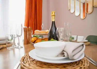 a dining room table with a bottle of wine and glasses at 3x Bed Elegant House with Private Parking in Sawston