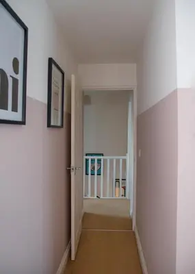 a hallway with white walls and an open door at 3x Bed Elegant House with Private Parking in Sawston