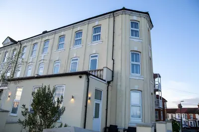 a large white building with windows on a street at Seaview Apartments - 28-29 Marine Parade, Harwich - Perfect for business & long term stays in Dovercourt