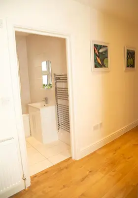 a bathroom with a sink and a mirror at Seaview Apartments - 28-29 Marine Parade, Harwich - Perfect for business & long term stays in Dovercourt