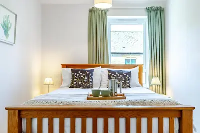a bedroom with a large bed with a window at Brunswick Terrace in Cambridge
