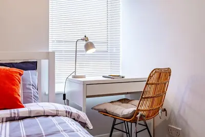 a bedroom with a desk and a bed and a chair at Brunswick Terrace in Cambridge