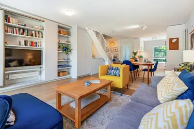 a living room with blue couches and a table at Brunswick Terrace in Cambridge
