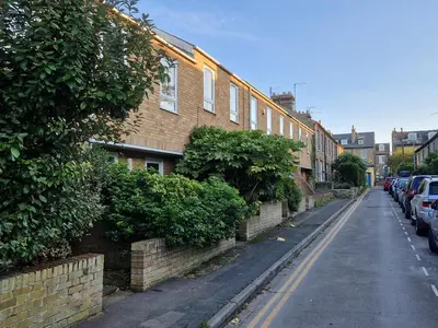 a street with cars parked on the side of a building at Brunswick Terrace in Cambridge