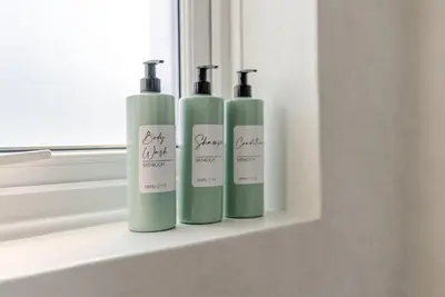 three green bottles sitting on a window sill at Brunswick Terrace in Cambridge