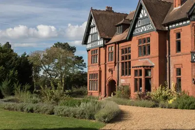 an old brick building with a garden in front of it at Royal Racing Retreat in Newmarket in Newmarket