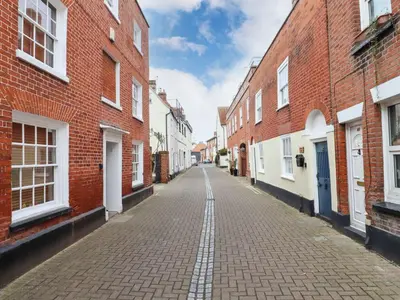 an empty street in an alley between brick buildings at Driftwood Cottage in Harwich