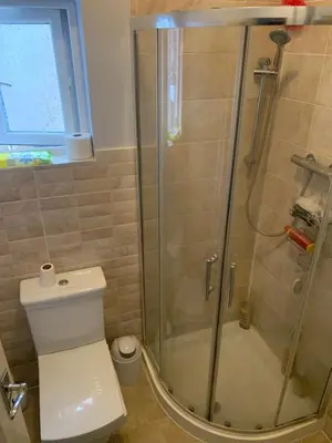 a bathroom with a glass shower with a toilet at Sami in Southend-on-Sea