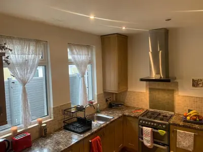 a kitchen with a sink and a stove top oven at Sami in Southend-on-Sea