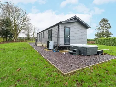 a tiny house sitting on top of a yard at Wurzburc in Swaffham