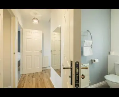 a white bathroom with a toilet and a sink at Chique & Modern Style Apartment in Cambridge