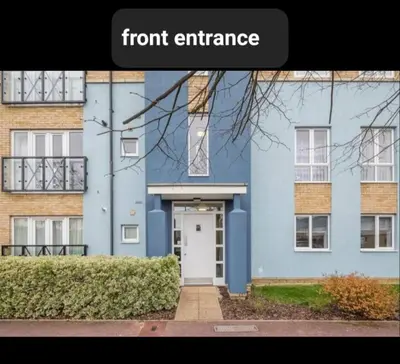 a front entrance of a blue building with a white door at Chique & Modern Style Apartment in Cambridge