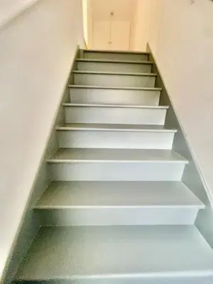 a staircase in a house with white steps at Modern 2 bedroom apartment in cambridge in Milton