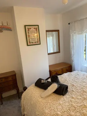 a bedroom with a bed with a stuffed animal on it at Chestnut Cottage in Great Ellingham