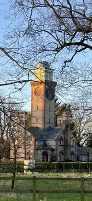 a building with a clock tower on top of it at Chestnut Cottage in Great Ellingham