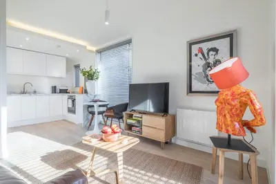 a living room with a mannequin standing on a chair at Fabulous Central Apt With Balcony & Parking in Cambridge