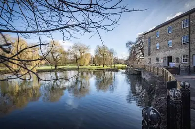 a river in front of a building next to a building at Fabulous Central Apt With Balcony & Parking in Cambridge