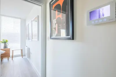 a door with a picture hanging on a wall at Luxury Central Apt Riverside Views & Parking in Cambridge