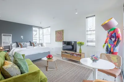 a living room with a couch and a tv at Superb Central Apt River Views & Parking in Cambridge