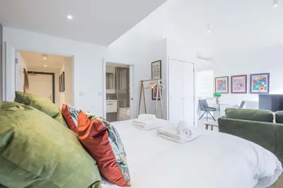 a living room with a bed and a couch at Stunning Central Apt - Balcony & Parking in Cambridge