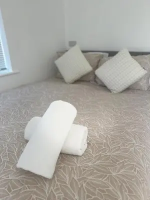 a bed with two white pillows on it at Colne cabin in Earls Colne