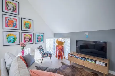 a living room with a couch and a flat screen tv at Beautiful Central Apt With Parking in Cambridge