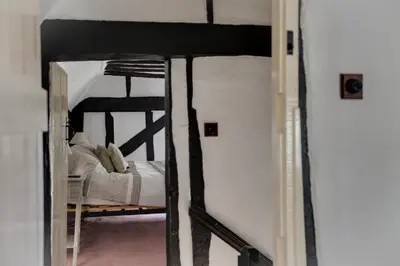 a doorway to a bedroom with a bunk bed at Willow Cottage in Saxtead