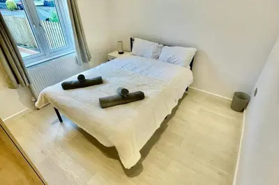 a bedroom with a bed with two black objects on it at 3 Bed Flat - Sleeps 6 - Parking - Wifi in Cambridge
