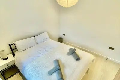 a bedroom with a bed with two stuffed animals on it at 3 Bed Flat - Sleeps 6 - Parking - Wifi in Cambridge
