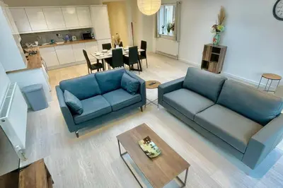 a living room with two blue couches and a table at 3 Bed Flat - Sleeps 6 - Parking - Wifi in Cambridge