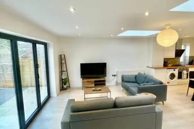 a living room with a couch and a tv at 3 Bed Flat - Sleeps 6 - Parking - Wifi in Cambridge