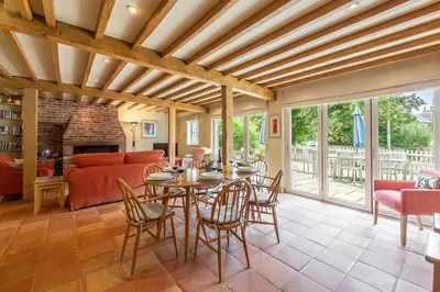 a living room with a table and chairs and a couch at The Granary, Hacheston 4 in Marlesford