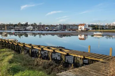a dock on a river with boats in the water at The Granary, Hacheston 4 in Marlesford