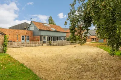 a large yard in front of a brick house at The Granary, Hacheston 4 in Marlesford