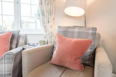 a living room with a couch with pillows on it at Milestone House, Aldeburgh in Aldeburgh