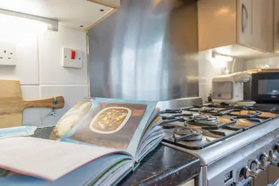 a kitchen with a stove with a plate of food on it at Milestone House, Aldeburgh in Aldeburgh
