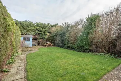 a small garden with a picnic table in the background at Milestone House, Aldeburgh in Aldeburgh