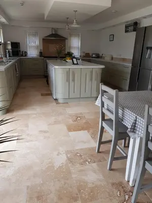 a large kitchen with a table and chairs in it at Tirah Guest House in Aldeburgh