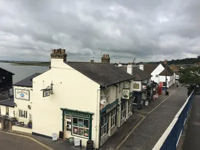 a group of buildings on a street next to the water at Charming 2-Bedroom Maisonette in Leigh-on-Sea