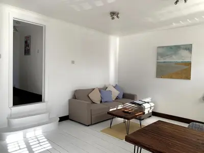 a living room with a couch and a table at Charming 2-Bedroom Maisonette in Leigh-on-Sea