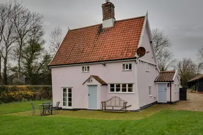 a large white house with a red roof at Willow cottage in Saxtead