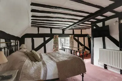 a bedroom with a large bed in a room at Willow cottage in Saxtead